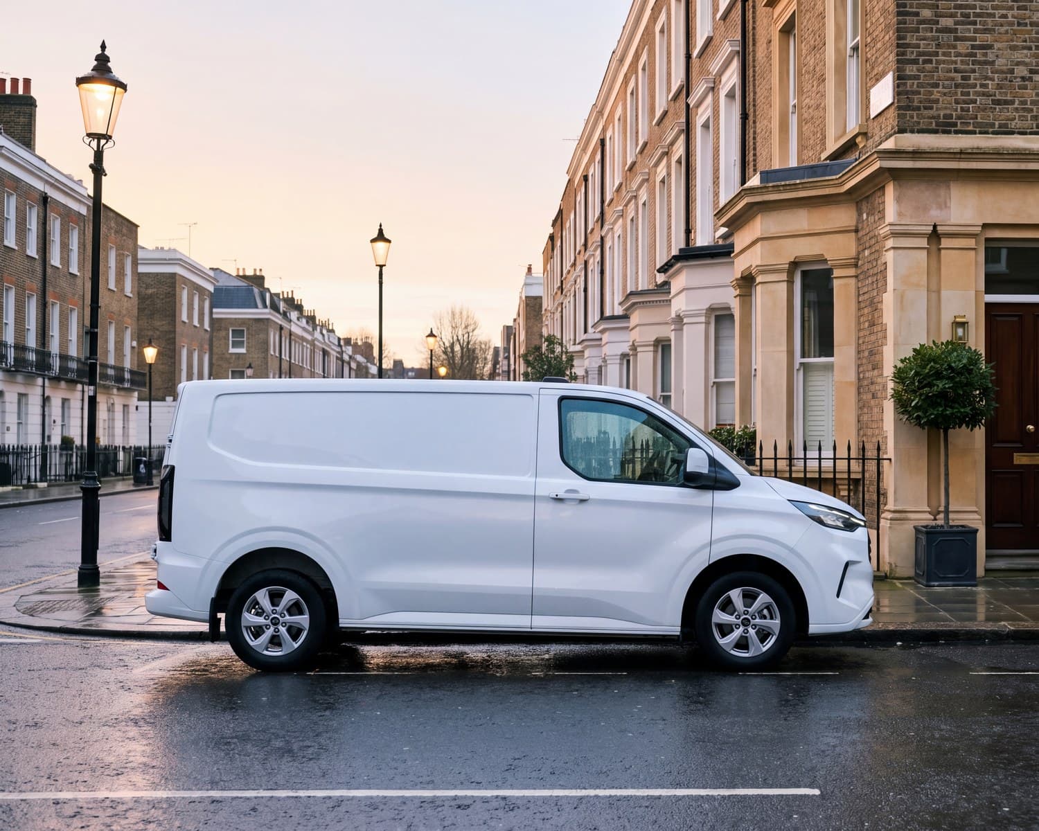 A white van parked on a London street at first light